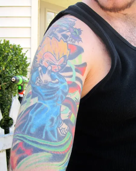 An upper arm filled with a bright, many-coloured design.